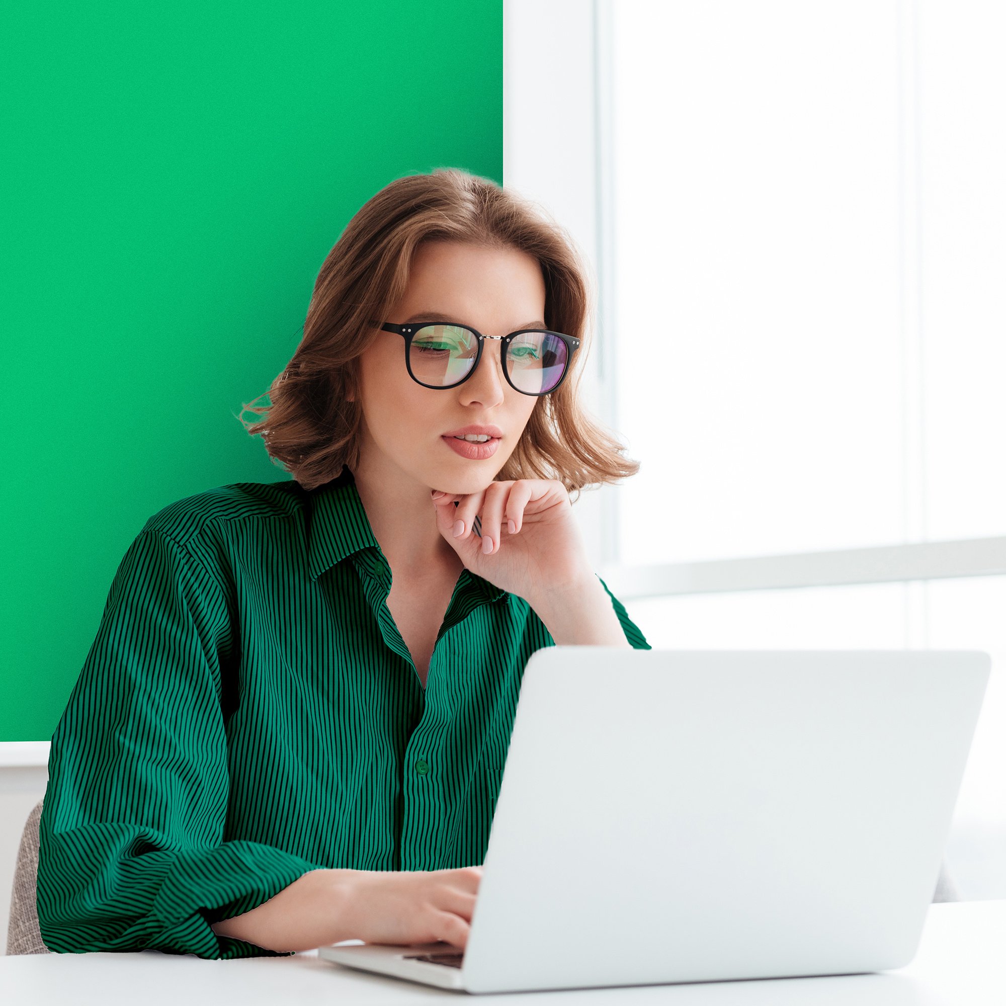 charming-businesswoman-glasses-striped-shirt-working-with-laptop-computer-while-siting-home copy